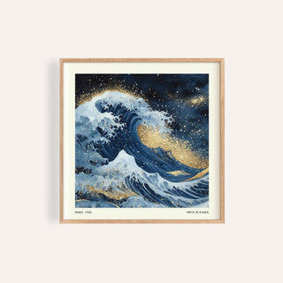 Close-up of wall art of the ocean with a blue wave and gold accents in a wooden frame