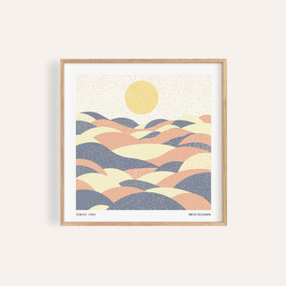 Framed pastel wall art with abstract hills in muted pink and blue tones and a yellow sun