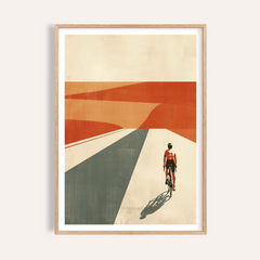 Framed cycling landscape print of a cyclist in red riding into an abstract desert with orange and grey shapes