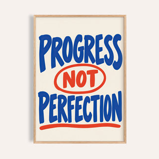 Progress Not Perfection print reading PROGRESS NOT PERFECTION in blue and red lettering
