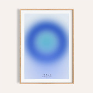 Deep blue and turquoise focus print shown on a plain warm wall