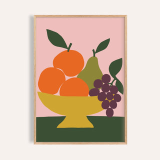 Fruit bowl print with oranges and grapes shown on a plain warm wall