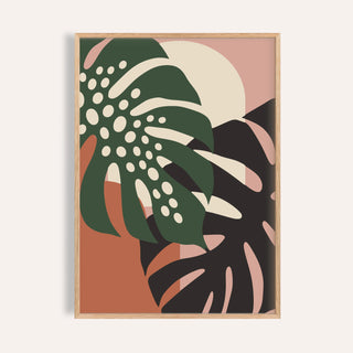 Tropical leaf print of two monstera leaves shown on a plain warm wall