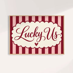 Above bed wall art with Lucky Us in burgundy script on pink and burgundy stripes