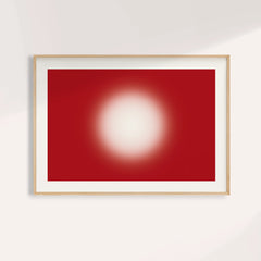 Red abstract wall art with a glowing cream orb on a deep cherry red ground