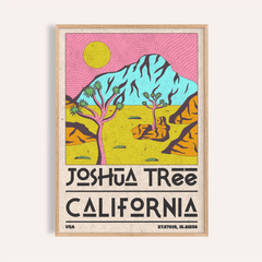 Framed Joshua tree art print with pink sky and yellow sun on a beige wall