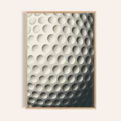 Framed close-up of textured golf ball art print in minimalist black and white style