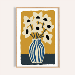 Framed art print flowers with cream flowers and blue striped vase against mustard background