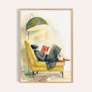 Woman Reading In Armchair Print of a woman in a yellow armchair with a green lamp and stack of books