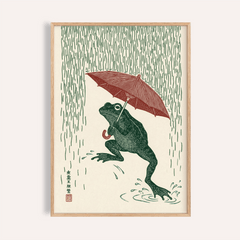Framed Frog In Rain Art Print of a green frog under a red umbrella with vertical rain lines
