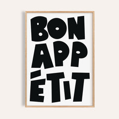 Framed close-up of French art prints with black bold typographic text saying Bon Appétit on white background