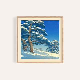 Framed Hasui Kawase Snowy Pines Art Print showing snow-covered pine trees under a blue sky