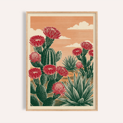 Framed Cactus Desert Art showing green cacti with red flowers and an orange sky background