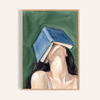 Framed print of woman reading portrait print with a blue book covering her face against a green background