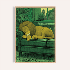 Framed Sleeping Lion Print of a yellow lion resting on a green sofa with plants in the background