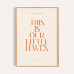 Centered quote wall art poster reading “This Is Our Little Haven” in orange serif type on beige