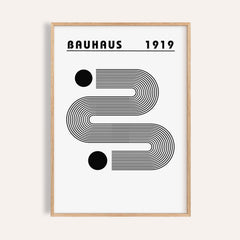Framed black and white minimalist art with curved linear shapes and two bold dots