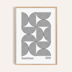 Framed Bauhaus wall art featuring black concentric semicircles and text on white background
