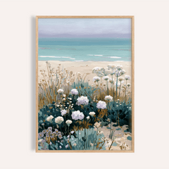 Framed print of Beach Floral Art with white beach flowers and muted greens against a sandy shore background
