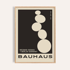 Framed Balancing Stones wall art with beige abstract circles on black background