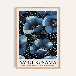 Framed print of blue flowers with white dots on black background in natural wood frame