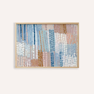 Framed print of pastel blue and pink abstract dots in a contemporary style in a light wood frame