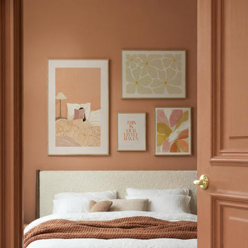 4-Piece Floral Wall Art Set above a bed with textured brown throw in a bedroom