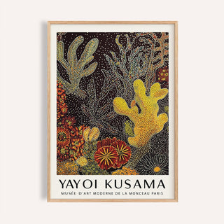 Framed print of coral reef art abstract with orange, yellow and red dots on a white wall
