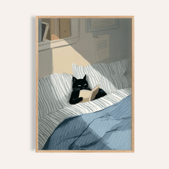 Framed Cat Reading Book wall art of a black cat with a beige book on striped bedding in soft lighting
