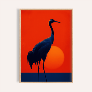 Framed print of crane silhouette against orange background with sun