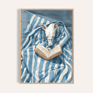 Framed Dog Reading Print of a white dog wearing glasses under a blue and white striped blanket