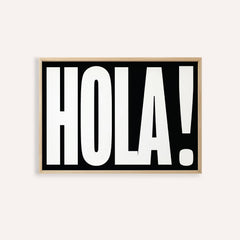 Framed print close-up of bold HOLA typography in black and white