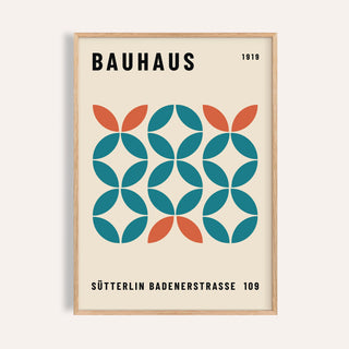 Framed print showing a geometric bauhaus pattern with teal and orange shapes on cream background