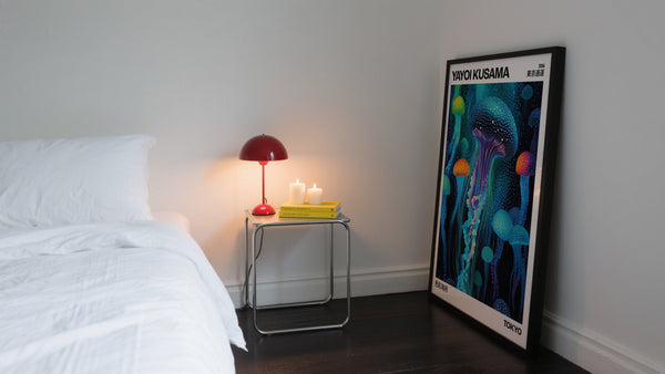 Bedroom with trendy wall art leaning on the wall next to a bed