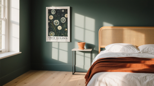 A bedroom with a framed Yayoi Kusama dandelion print used as art for green wall decor.