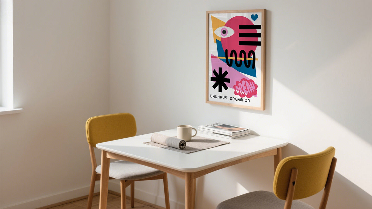 Framed Bauhaus-style cute prints poster in bright kitchen above dining table
