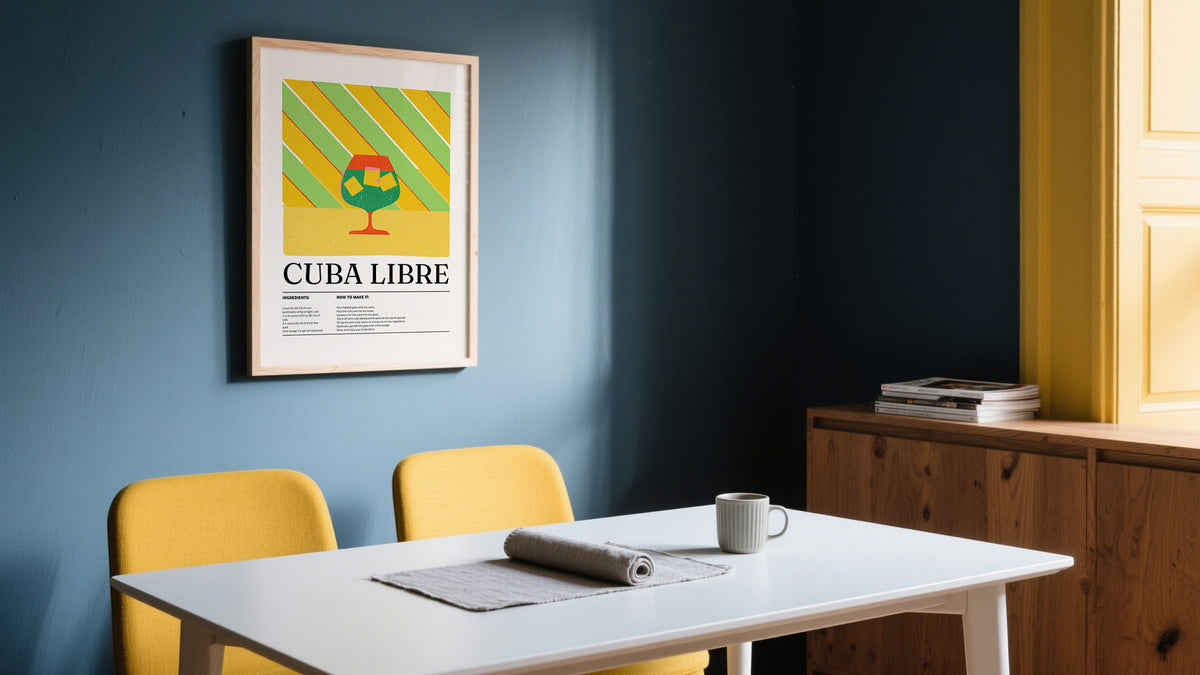 A bold Cuba Libre-themed cocktail hanging wall print framed on a blue wall in a modern dining room