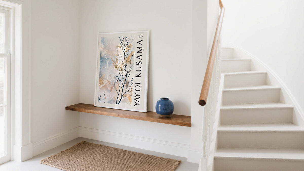 Framed floral print styled as spring wall art on a wooden console in a cozy, sunlit entrance hallway