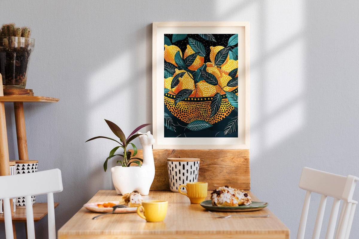 Framed abstract large wall art of golden lemons and green leaves hanging above a cozy breakfast nook with modern decor.