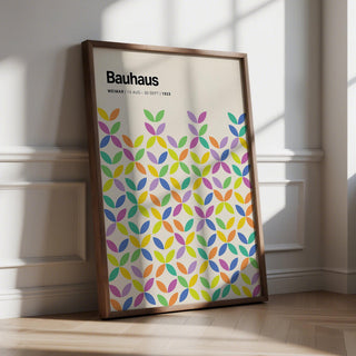Colorful Bauhaus poster featuring overlapping petal shapes in green, purple, and yellow on a cream background.