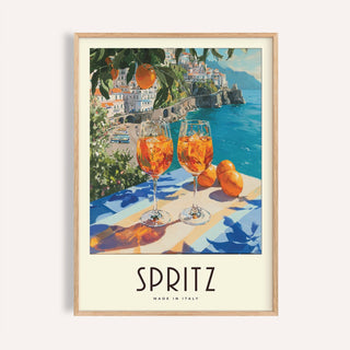 Cocktail Art Decor framed print close-up of two orange spritz glasses with coastal town background