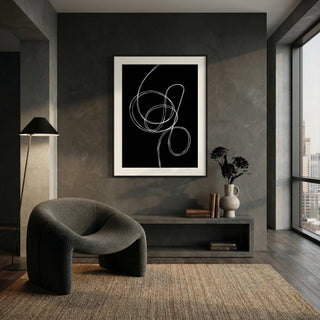 Modern interior with a dark gray armchair, abstract artwork on the wall, and a cityscape view.