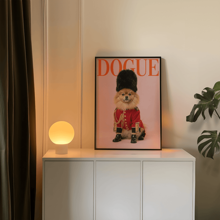 Pomeranian Poster Print leaning on a cabinet with warm lamp light and a green plant nearby