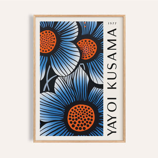 Framed print close-up showing blue flowers with orange centers and text on the side