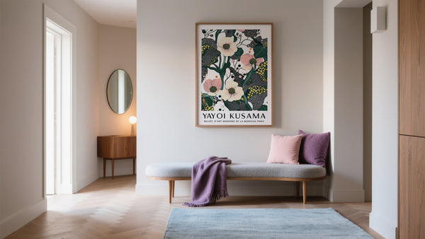 Modern interior with a floral artwork by Yayoi Kusama on a wall, a bench with cushions, and a rug.