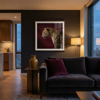 Modern living room with a dark gray sofa, decorative pillow, and a framed picture of a leopard on the wall.