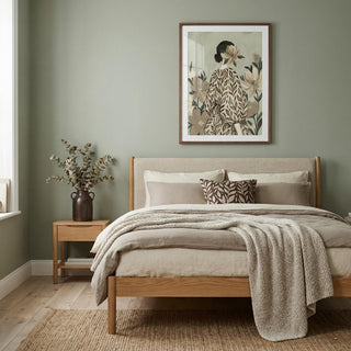 Bedroom with wooden bed, beige bedding, and a framed artwork on the wall.