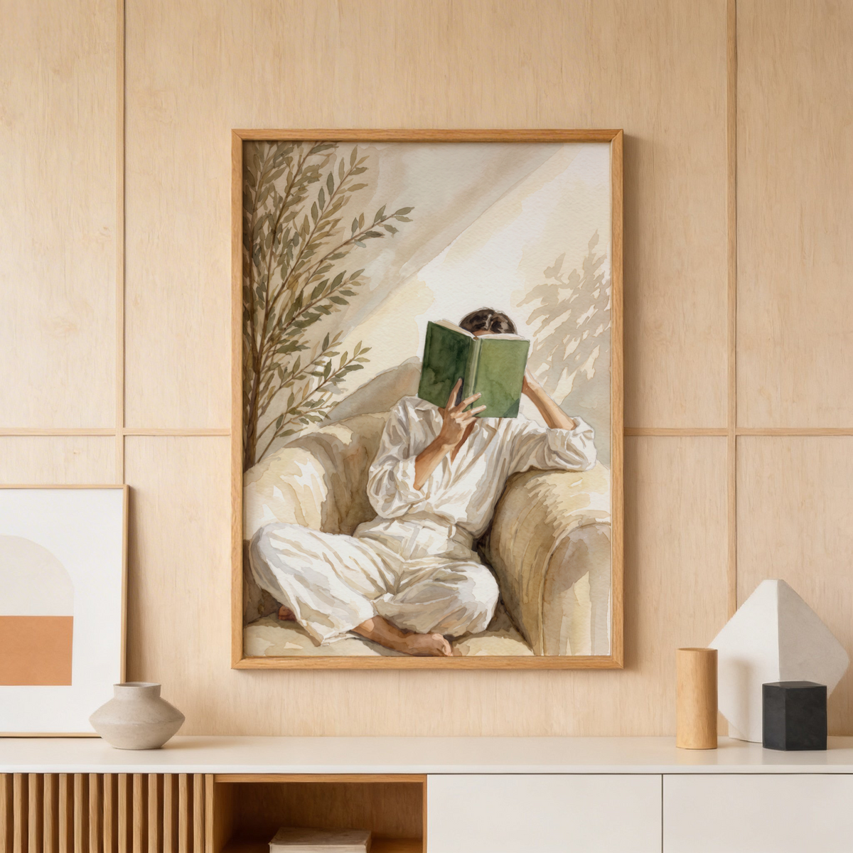 Close-up wall art print showing woman holding an open book with leafy branches behind