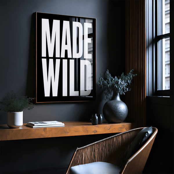 Modern typographic wall decor displayed above desk workspace