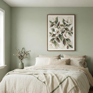 Neatly made bed with beige bedding in a room with a floral painting on the wall.